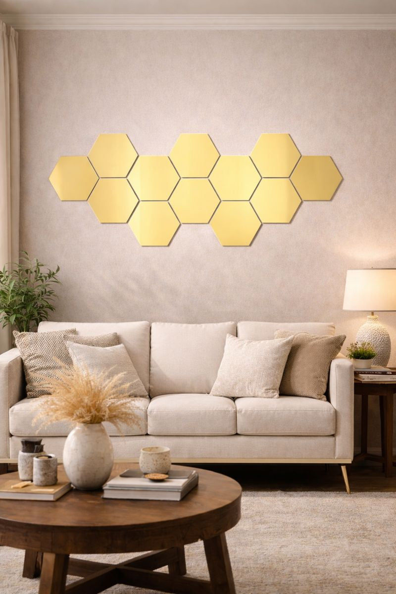Hexagonal mirror panels on a wall above a sofa in a living room.