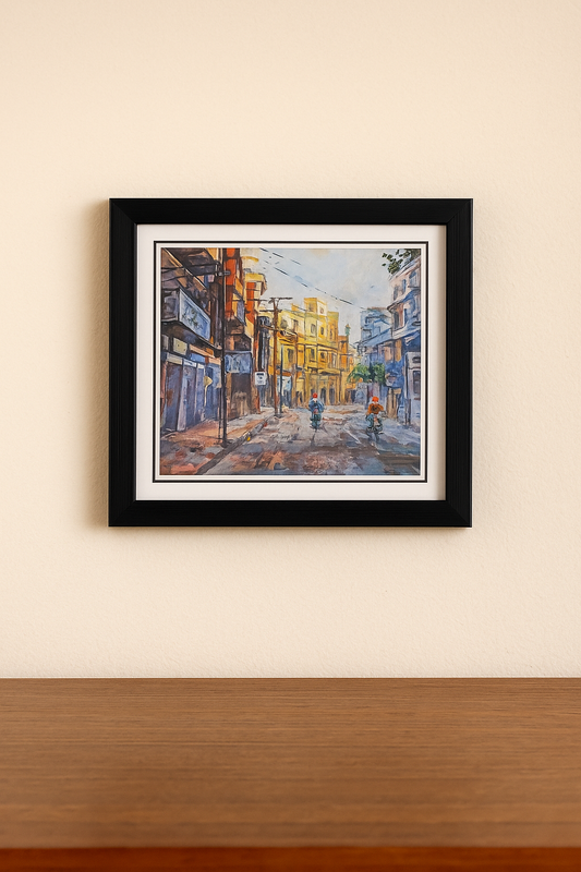 Framed painting of a city street scene on a beige wall.