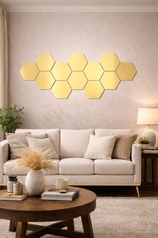Hexagonal mirror panels on a wall above a sofa in a living room.