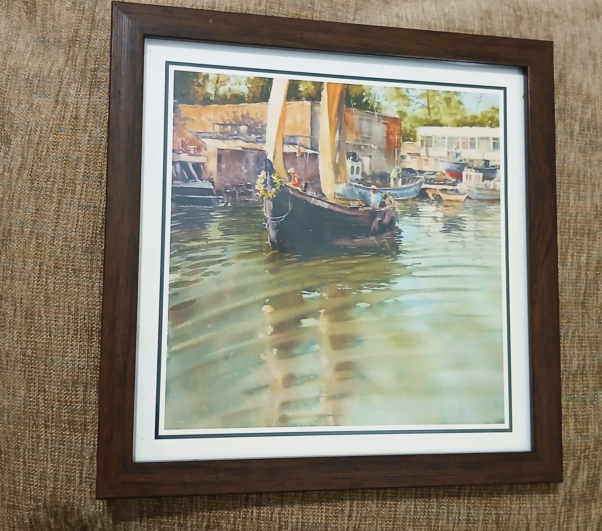 Framed photo of a sailboat in a harbor with beige sails, compact 8.5 x 8.5 inch wall art in a wooden frame.