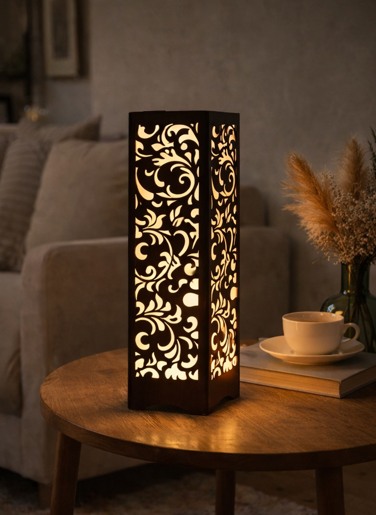 Decorative table lamp with intricate patterns on a wooden table in a cozy living room.